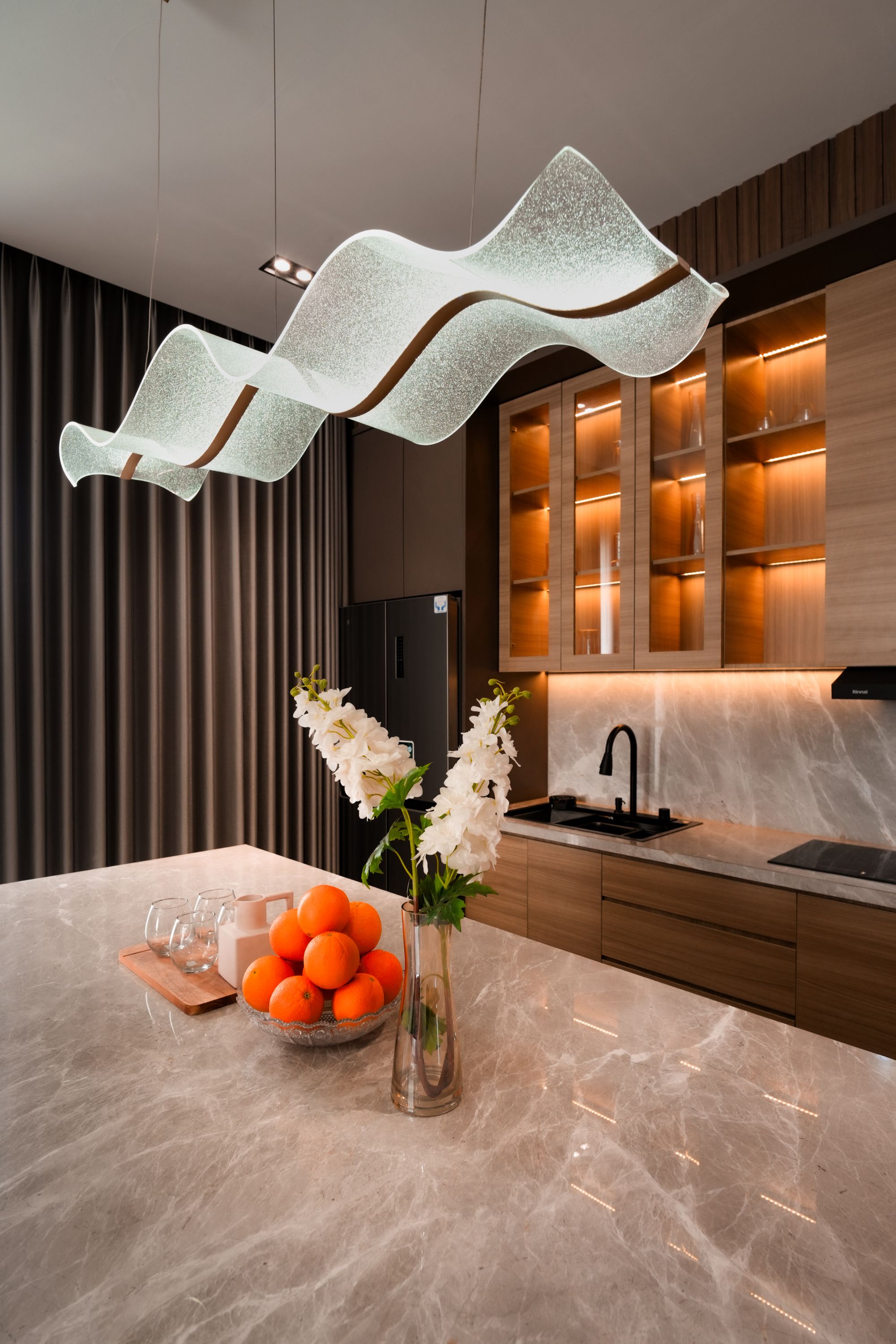 Refined contemporary kitchen with warm architectural lighting
